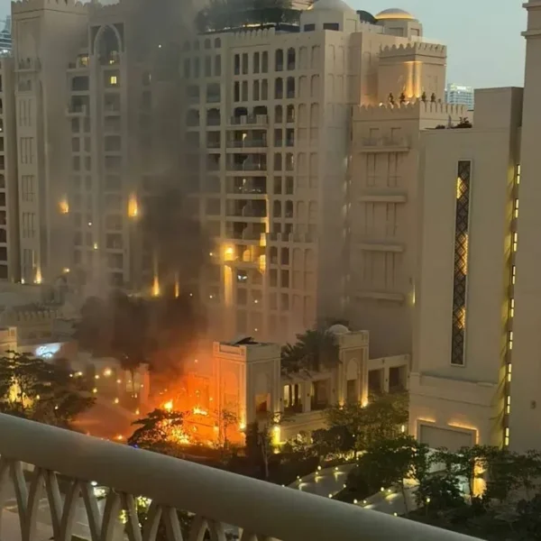 Top Dubai hotel on Palm Jumeirah in flames after being hit by missile debris from Iran blitz