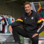 Former Liverpool coach Jurgen Klopp warns up as he becomes new head coach of Germany
